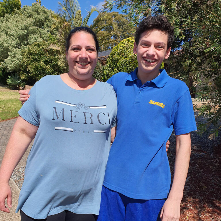 Mother smiling and happy with her NDIS client son.